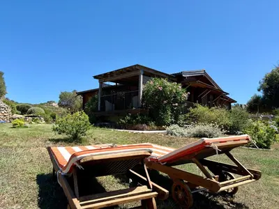 a wooden cart in front of a house at Chalet Maria in Bonifacio