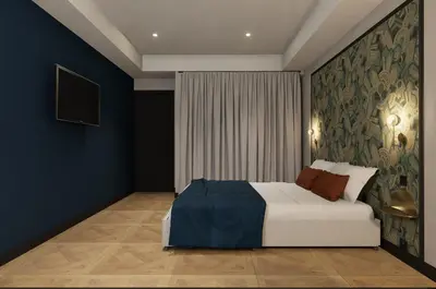 a bedroom with a bed and a wall mural at Grand Hôtel de la Scala in Calacuccia