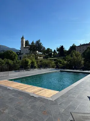 a swimming pool in the middle of a courtyard at Grand Hôtel de la Scala in Calacuccia