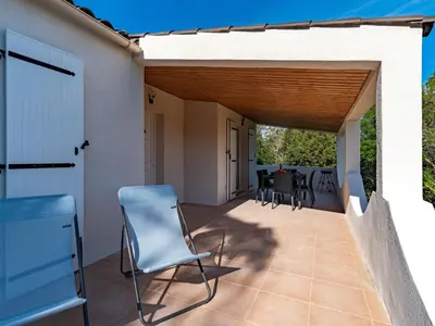 a patio with chairs and a table on it at Holiday Home Villa Bruzzi by Interhome in Pianottoli-Caldarello