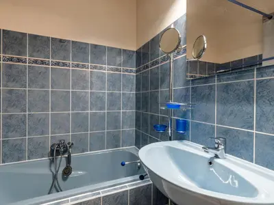 a bedroom with a bed and a dresser with towels on it at Holiday Home La Girelle by Interhome in Porto-Vecchio
