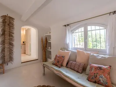 a living room with a white couch and a window at Villa Villa Casaben by Interhome in Porto-Vecchio