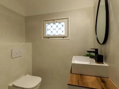 a bathroom with a toilet and a sink and a window at Villa Villa Casaben by Interhome in Porto-Vecchio