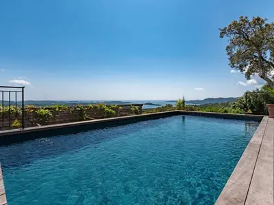 a swimming pool with a view of the ocean at Villa Villa Casaben by Interhome in Porto-Vecchio