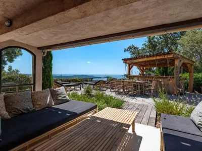 a patio with a couch and a pergola at Villa Villa Casaben by Interhome in Porto-Vecchio