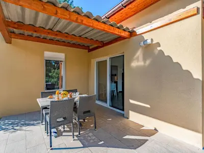 a table and chairs on a patio at Apartment Residence Marina di Favone- T2- 2-4 pers-3 by Interhome in Conca