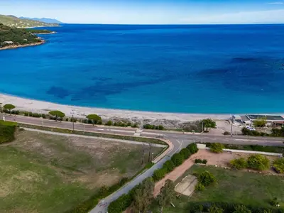 a park with benches and the ocean in the background at Apartment Residence Marina di Favone- T2- 2-4 pers-3 by Interhome in Conca