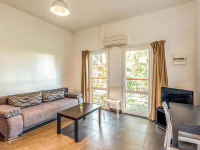 a kitchen and a living room with a couch at Apartment Residence Marina di Favone- T2- 2-4 pers-3 by Interhome in Conca