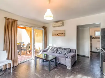 a bedroom with a bed and a large window at Apartment Residence Marina di Favone- T3- 4-6 pers-4 by Interhome in Conca