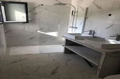 a bathroom with a sink and a shower and a tub at Les Jardins d'Eve, Solenzara, townhouse with private pool in Favone