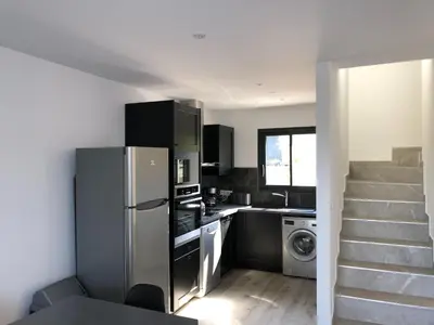 a kitchen with a refrigerator and a washer and dryer at Les Jardins d'Eve, Solenzara, townhouse with private pool in Favone