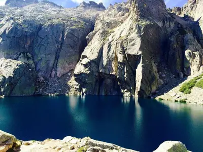 a large blue lake in the middle of a mountain at Les Jardins d'Eve, Solenzara, townhouse with private pool in Favone