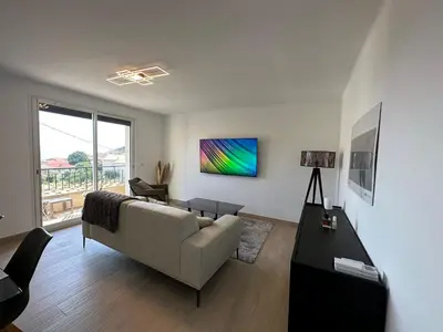 a living room with a couch and a table at Alivu - Appartement Moderne Avec Terrasse in Cargèse