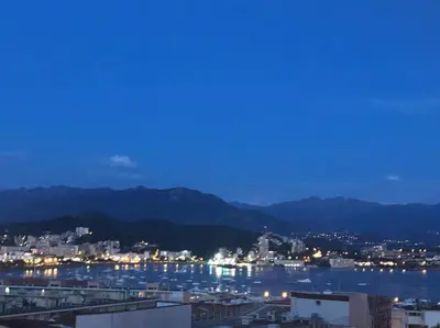 a city at night with cars parked on a street at Très bel appartement avec terrasse de 87m2 avec une superbe vue panoramique sur la baie d Ajaccio in Ajaccio