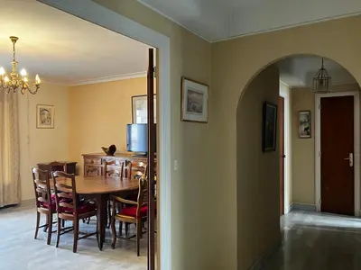 a hallway with an archway in a room with a mirror at Très bel appartement avec terrasse de 87m2 avec une superbe vue panoramique sur la baie d Ajaccio in Ajaccio