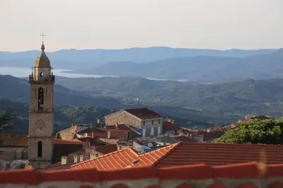 a view of a town with a clock tower at appartement en rez de jardin in Foce