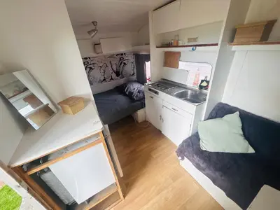 a small room with a kitchen and a sink at Caravane janis on the beach in Lucciana