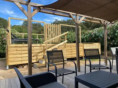 a group of chairs and tables under a gazebo at Villa Dominique Porto-Vecchio proche des plages in Porto-Vecchio