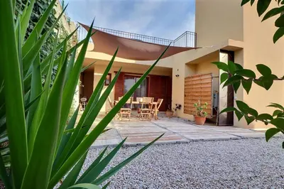 a house with a patio with a table and chairs at Maison U CASTAGNU in Santa-Reparata-di-Balagna