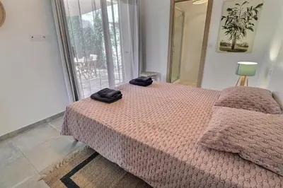 a bedroom with a bed with two black towels on it at Maison U CASTAGNU in Santa-Reparata-di-Balagna
