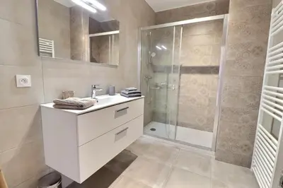 a bathroom with a white sink and a shower at Maison U CASTAGNU in Santa-Reparata-di-Balagna