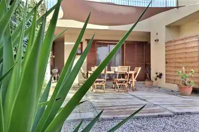 a patio with a table and chairs and plants at Maison U CASTAGNU in Santa-Reparata-di-Balagna