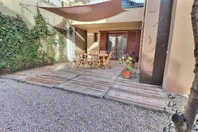 a wooden deck with a table and chairs on a house at Maison U CASTAGNU in Santa-Reparata-di-Balagna