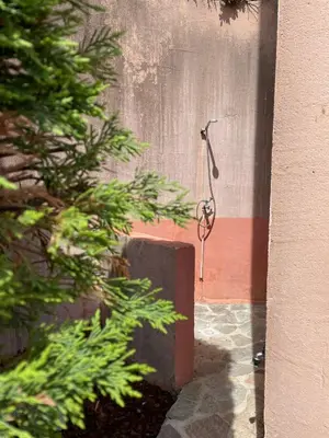 a shower in the side of a building at Maison de Lou in Porticcio