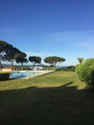 a park with a fence and a swimming pool at Maison de Lou in Porticcio