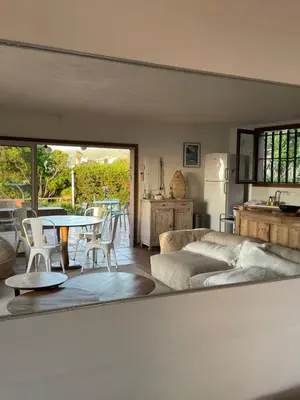 a living room with a couch and a table at Maison de Lou in Porticcio