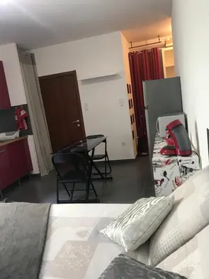 a bedroom with a bed and a table and a kitchen at Studio CORTE in Corte