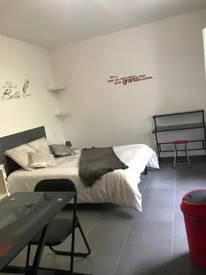 a bedroom with a bed with a table and chairs at Studio CORTE in Corte
