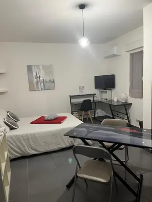 a room with a bed and a table with chairs at Studio CORTE in Corte