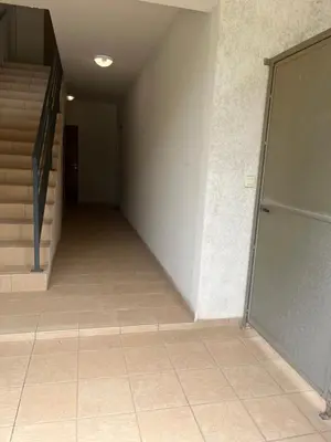 an empty hallway with stairs and a glass door at Studio CORTE in Corte