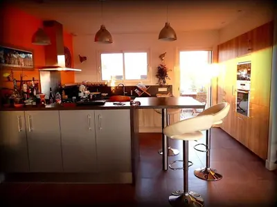 a kitchen with a counter and a table and chairs at NEW Villa with JACUZZI, near St Cyprien beach in Lecci