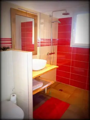 a red bathroom with a sink and a shower at NEW Villa with JACUZZI, near St Cyprien beach in Lecci