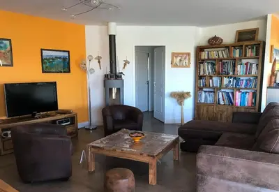 a living room with a couch and a coffee table at NEW Villa with JACUZZI, near St Cyprien beach in Lecci