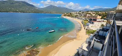 a view of a beach with boats in the water at T2 de Standing Coté Plage, les pieds dans l'eau in Propriano