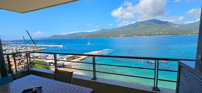 a balcony with a view of a body of water at T2 de Standing Coté Plage, les pieds dans l'eau in Propriano