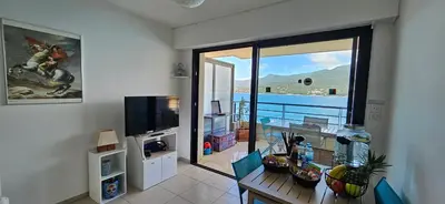a living room with a view of the ocean at T2 de Standing Coté Plage, les pieds dans l'eau in Propriano
