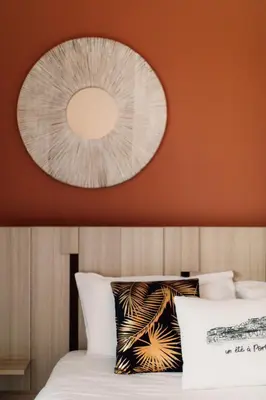 a bedroom with a mirror above a bed at La Clé Terrasse, Proche port,centre, parking,clim in Porto-Vecchio
