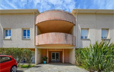 a building with a large circle on the front of it at Lovely Apartment In Sta Maria Poggio in Moriani Plage