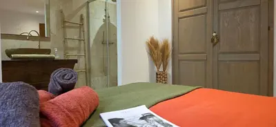 a living room with a table and a couch at A Pasturella, Jacuzzi Spa in Venzolasca