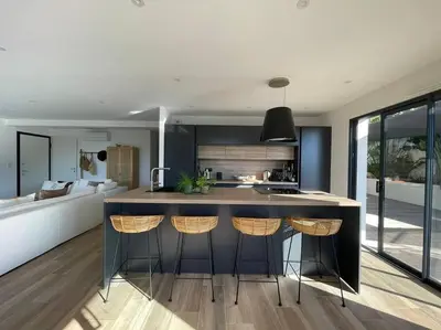a kitchen with a island with bar stools at Maison villa 3 chambres plage Agosta proche Porticcio in Pietrosella