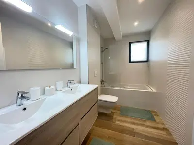 a bathroom with a sink and a toilet and a mirror at Maison villa 3 chambres plage Agosta proche Porticcio in Pietrosella
