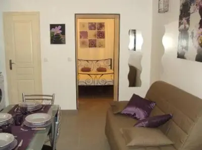 a living room with a couch and a table at Charmant T2 proche de Corte in Soveria