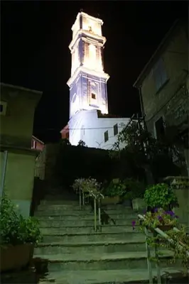 a tall tower with a clock on top of a building at Charmant T2 proche de Corte in Soveria
