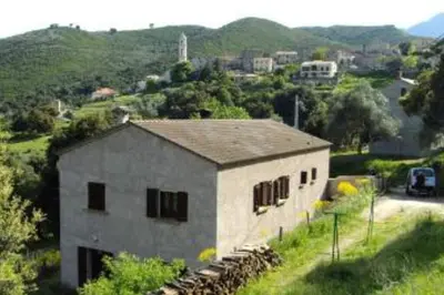 a large building on the side of a road at Charmant T2 proche de Corte in Soveria
