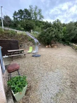 a park with a bench and a playground at Charmant T2 proche de Corte in Soveria