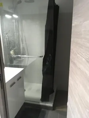 a glass cabinet with a black bag inside of it at Prunete - Appartement - 2 personnes - Piscine in Cervione